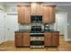 Stylish kitchen featuring a stainless steel oven, granite countertops, and modern appliances at 4416 Brighton Ridge Dr, Apex, NC 27539