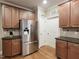 Well-equipped kitchen with stainless steel refrigerator, granite countertops, and ample storage at 4416 Brighton Ridge Dr, Apex, NC 27539