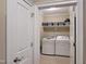 Neat laundry room with washer, dryer, shelf and storage baskets at 4416 Brighton Ridge Dr, Apex, NC 27539