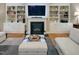 Cozy living room with a fireplace, built-in bookshelves, and plush sofas at 4416 Brighton Ridge Dr, Apex, NC 27539