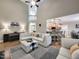 Open-concept living room with high ceilings, fireplace, and access to the kitchen at 4416 Brighton Ridge Dr, Apex, NC 27539