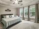 Spacious main bedroom with tray ceiling, carpet, and multiple windows at 4416 Brighton Ridge Dr, Apex, NC 27539