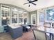 Inviting screened-in porch boasts comfortable seating, ceiling fan, and ample natural light at 4416 Brighton Ridge Dr, Apex, NC 27539