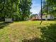 This backyard has a large grassy area, a shed, and mature trees at 4428 W West River Rd, Franklinton, NC 27525