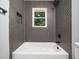 Close-up view of the modern tiled shower and tub in the bathroom at 4428 W West River Rd, Franklinton, NC 27525