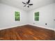 This light-filled bedroom features hardwood floors and a ceiling fan at 4428 W West River Rd, Franklinton, NC 27525