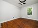 This bedroom offers hardwood floors, a ceiling fan, and bright natural light at 4428 W West River Rd, Franklinton, NC 27525