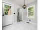 Bright entryway with marble floors, a modern light fixture, and views into a sun-lit space at 4428 W West River Rd, Franklinton, NC 27525