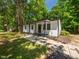 A charming home with a welcoming front porch and a well-maintained walkway surrounded by lush greenery at 4428 W West River Rd, Franklinton, NC 27525