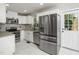 Bright kitchen with white cabinets, stainless steel appliances, and granite countertops at 4428 W West River Rd, Franklinton, NC 27525