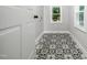 Well-lit laundry room features patterned tile flooring and a view of the outdoors at 4428 W West River Rd, Franklinton, NC 27525