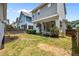 Spacious backyard with a well-maintained lawn, charming covered porch, and privacy fence at 444 Claremont Dr, Chapel Hill, NC 27516