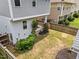 Aerial view of a backyard with covered porch and garden, fenced in yard, and green lawn at 444 Claremont Dr, Chapel Hill, NC 27516