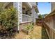Backyard featuring a cozy covered porch, garden beds, and a privacy fence with access gate at 444 Claremont Dr, Chapel Hill, NC 27516