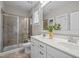 Bathroom features a double sink vanity, a glass enclosed shower, and neutral tile flooring at 444 Claremont Dr, Chapel Hill, NC 27516