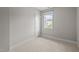 Bright and airy bedroom with neutral carpet and a window view at 444 Claremont Dr, Chapel Hill, NC 27516
