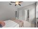 Bright bedroom features neutral walls, a ceiling fan, and access to a modern bathroom at 444 Claremont Dr, Chapel Hill, NC 27516