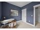 Bedroom with blue walls, white trim, carpet, and desk with art at 444 Claremont Dr, Chapel Hill, NC 27516