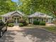 Community clubhouse with ample parking, manicured landscaping, and easy access at 444 Claremont Dr, Chapel Hill, NC 27516