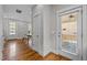 Hallway with gleaming hardwood floors, an exit to the front porch, and dining area views at 444 Claremont Dr, Chapel Hill, NC 27516