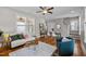 Inviting living room featuring hardwood floors, ceiling fan, comfortable seating, and a stylish coffee table at 444 Claremont Dr, Chapel Hill, NC 27516