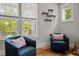 Cozy sitting area with stylish armchairs, decorative shelving, and plenty of natural light at 444 Claremont Dr, Chapel Hill, NC 27516