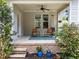 Charming covered porch with seating, ceiling fan, and brick accents provides a cozy outdoor space at 444 Claremont Dr, Chapel Hill, NC 27516
