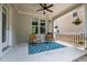 Covered porch with ceiling fan, outdoor seating, and patterned rug at 444 Claremont Dr, Chapel Hill, NC 27516