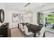 Elegant dining room features modern lighting, dark wood table, and access to an outdoor patio at 45 Shady Creek Way, Fuquay Varina, NC 27526