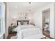 Cozy main bedroom featuring a stylish chandelier, bedside tables, and ensuite bathroom for added convenience at 45 Shady Creek Way, Fuquay Varina, NC 27526