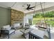 Inviting outdoor patio with stone fireplace, comfortable seating, and views of the backyard at 45 Shady Creek Way, Fuquay Varina, NC 27526