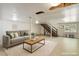 Finished basement area with recessed lighting, a comfortable couch, and access to wooden stairs at 4501 Zebulon Rd, Zebulon, NC 27597