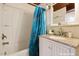 Bathroom with blue shower curtain and white vanity at 4501 Zebulon Rd, Zebulon, NC 27597