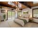 Bright bedroom with wood ceiling, ceiling fan, and access to a private balcony overlooking the trees at 4501 Zebulon Rd, Zebulon, NC 27597