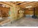 Rustic interior with a work area labeled 'Woodshop..Playroom' and a vintage wood burning stove at 4501 Zebulon Rd, Zebulon, NC 27597