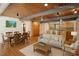 Open-concept living and dining area featuring wood floors, a light sofa, and modern decor at 4501 Zebulon Rd, Zebulon, NC 27597
