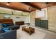 Inviting living room features a stone fireplace, wood ceiling beams, and comfortable seating at 4501 Zebulon Rd, Zebulon, NC 27597