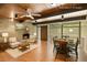 Spacious living room with a stone fireplace, comfortable seating, and natural light from large windows at 4501 Zebulon Rd, Zebulon, NC 27597