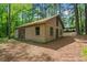 Exterior view of the wood sided outbuilding with dual doors and three windows at 4501 Zebulon Rd, Zebulon, NC 27597