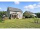 Expansive backyard with a house, fenced area, mature trees, and plenty of green space, ideal for outdoor gatherings at 456 Majestic Oak Dr, Garner, NC 27529