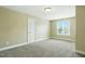 This carpeted bedroom has a window and a neutral color scheme at 456 Majestic Oak Dr, Garner, NC 27529