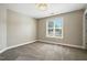 This carpeted bedroom has a window and neutral paint at 456 Majestic Oak Dr, Garner, NC 27529
