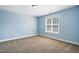 This carpeted bedroom has a window and light blue paint at 456 Majestic Oak Dr, Garner, NC 27529