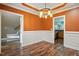 Dining room showcasing a tray ceiling, chair rail molding, and a doorway that shows the staircase at 456 Majestic Oak Dr, Garner, NC 27529