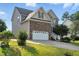 Two-story home showcasing a brick and siding exterior, a two-car garage, and a green lawn at 456 Majestic Oak Dr, Garner, NC 27529