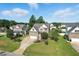 Well-manicured front yard with a two-story brick home, mature trees, and an attached garage at 456 Majestic Oak Dr, Garner, NC 27529