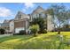 View of a two-story home featuring a brick facade, a two-car garage, and a well-maintained green lawn at 456 Majestic Oak Dr, Garner, NC 27529