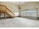 Spacious garage with overhead door and staircase to additional storage above at 456 Majestic Oak Dr, Garner, NC 27529