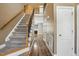 Inviting hallway with wood floors, carpeted stairs, and view of a fireplace in the living room at 456 Majestic Oak Dr, Garner, NC 27529