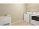 This laundry room features a utility sink and appliances at 456 Majestic Oak Dr, Garner, NC 27529